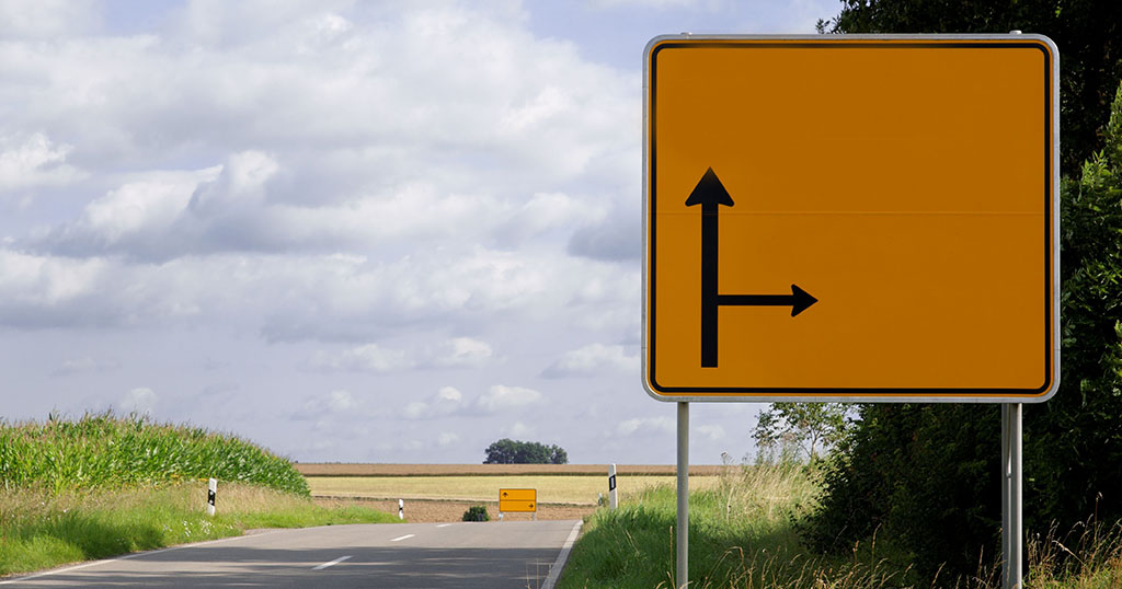 Yellow street sign on the side of the road